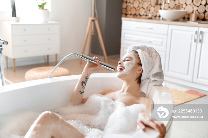 Young woman singing while taking bath at home