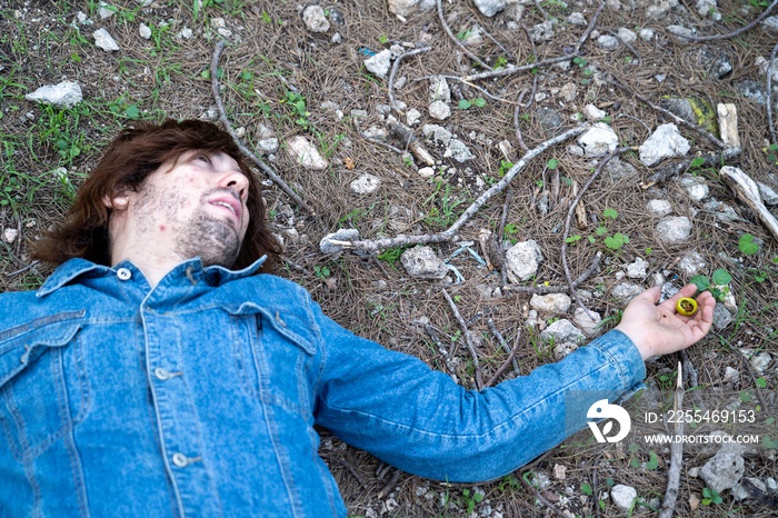 Close up of a dead young caucasian man after eating a venomous berry picked up from the forest