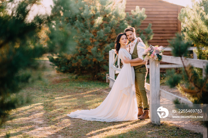 stylish romantic couple standing and hugging on ranch