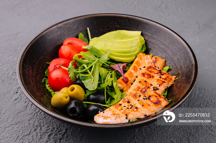 salad with grilled salmon, avocado, tomatoes with arugula