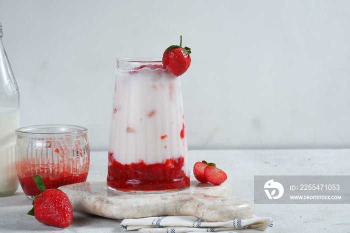 a glass of korean strawberry milk and berries.bright mood,white background.