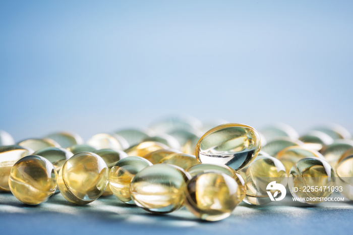 Bunch of vitamin D capsules laying on the table.