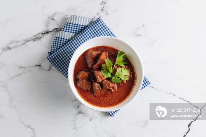 Mutton Rogan Josh, mutten qorma, mutten curry, mutton karahi in a dish isolated on napkin side view on grey background