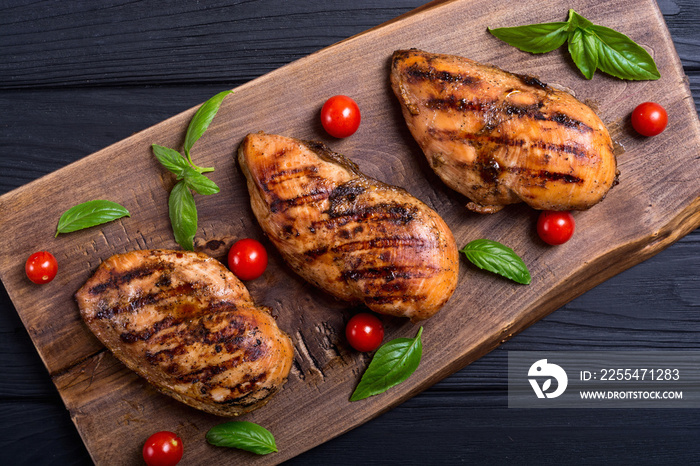 Grilled chicken breast ( fillet ) with basil and tomatoes