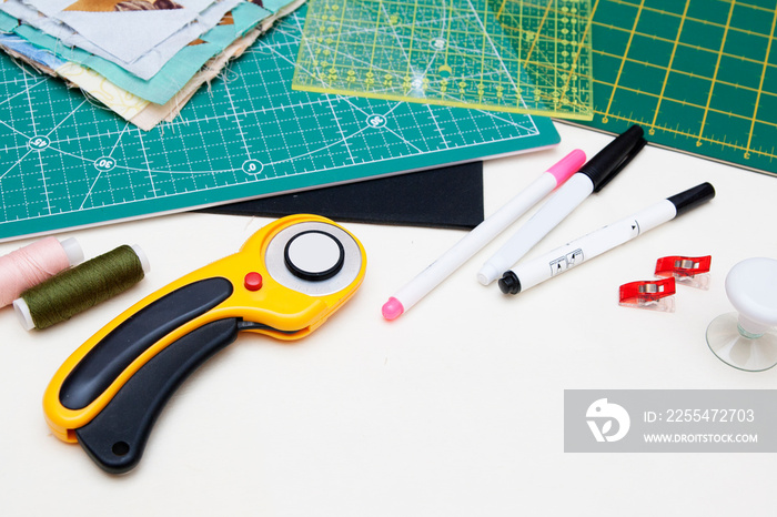 quilting tools - rugs, knife, ruler, felt-tip pens on white background