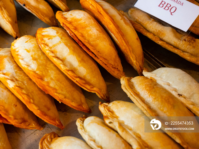 Closeup of baked snack empanada at market, popular spanish street food