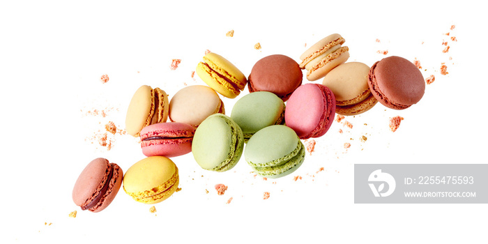 French  sweet colorful  mixed cookies macarons macaroons with crumbs flying isolated