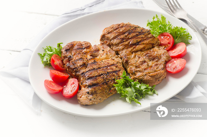 Grilled pork steak and vegetable salad