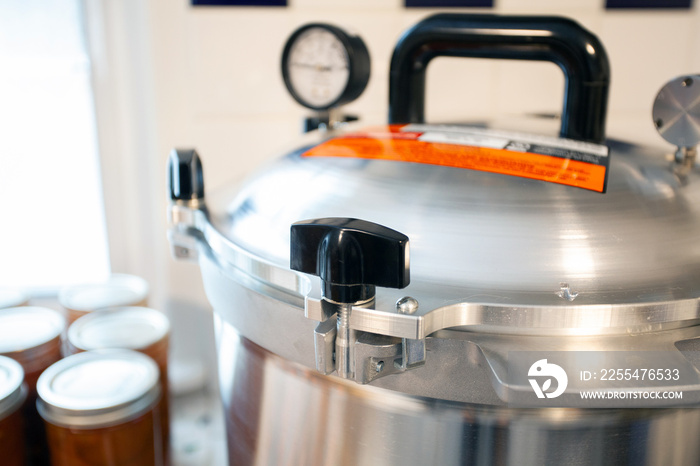 Close up of the lid to a pressure canner. Food preservation is key to gardening and homesteading. Pressure canning makes food shelf stable.