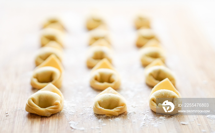 Fresh Tortellini pasta on a wooden board