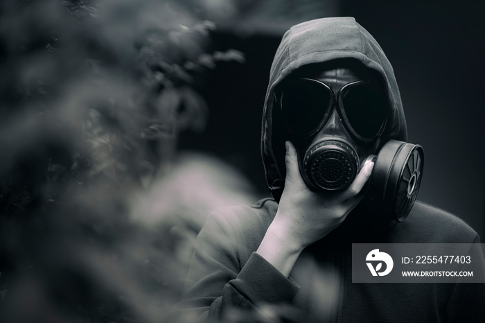 A man wearing a gas mask  and the gloomy atmosphere