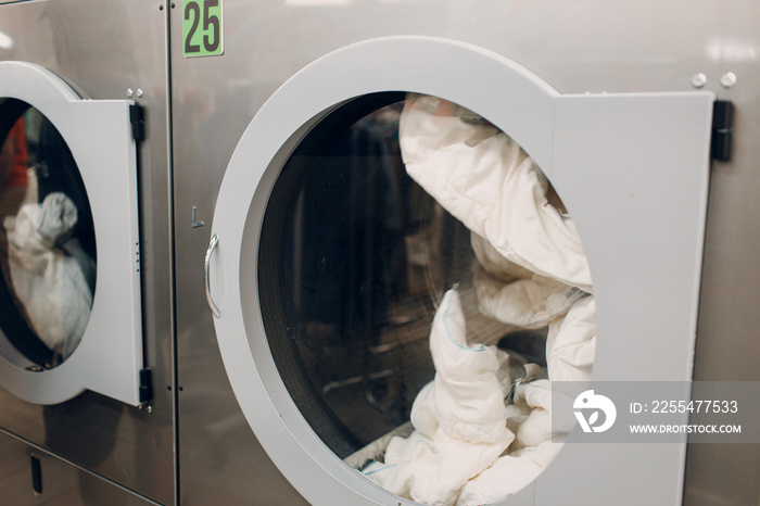 Dry cleaning clothes. Clean cloth dryer chemical process. Laundry industrial dry-cleaning factory