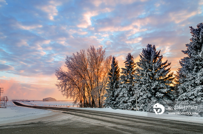 Winter sunset on a country road leading to the farm