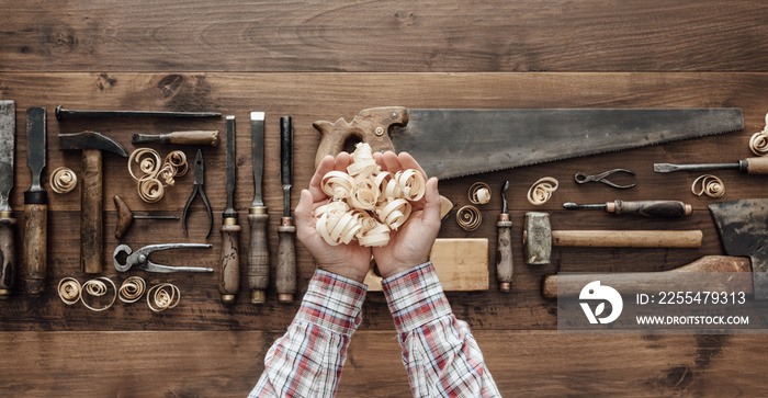 Carpenter holding wood shavings