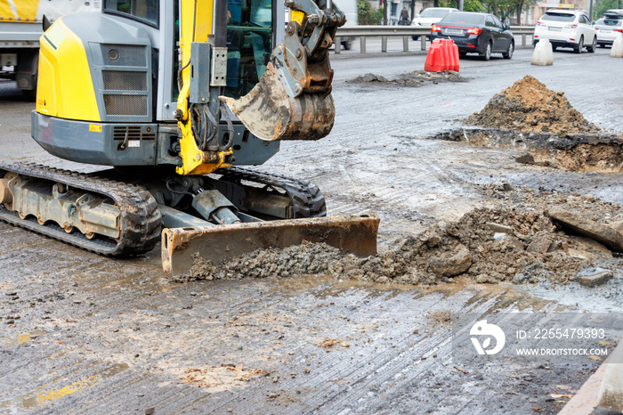 A mobile road excavator is working on the repair of a city road.