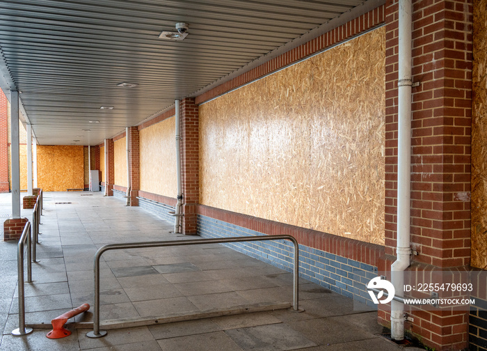 Boarded up windows of a supermarket that has recently  closed down.