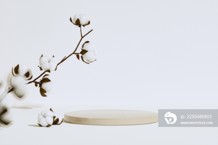 Minimal composition with Branch white cotton flowers, wooden podium on beige background. Delicate light beauty cotton background. Natural organic fiber, raw materials for making fabric. 3d render