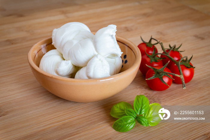 Composition of tomatos, basil and cows milk mozzarella cheese handmade in Puglia, Italy