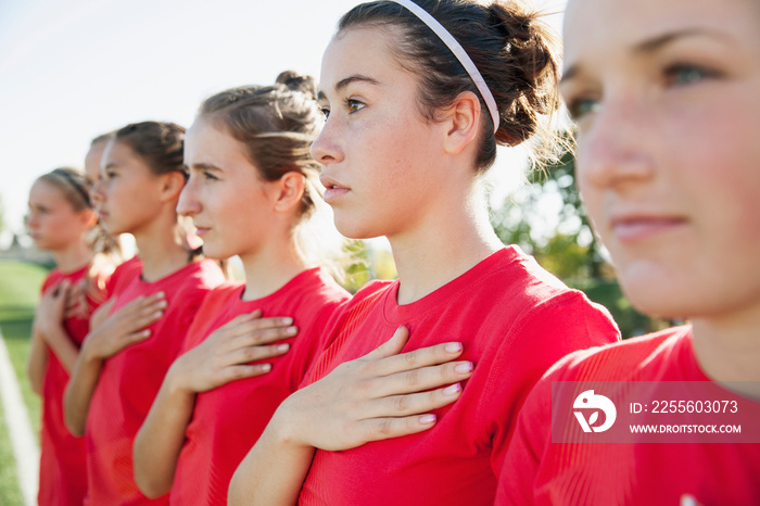 Soccer girls with hands on their hearts