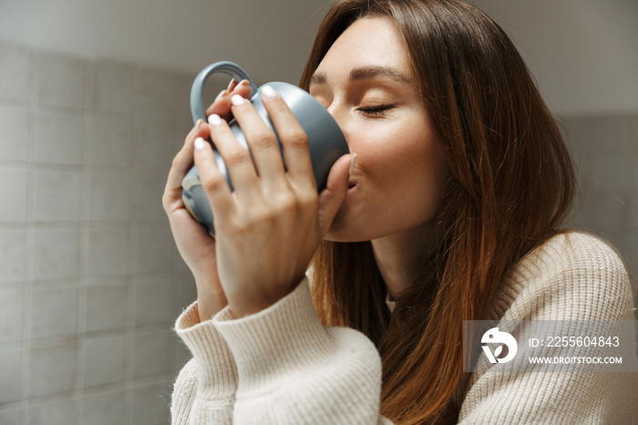 Lovely young girl drinking tea