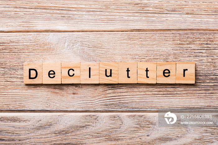 Declutter word written on wood block. Declutter text on wooden table for your desing, concept