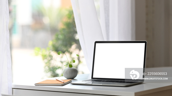 Comfortable workplace. Computer laptop with white blank screen putting together with Notebook, Diary