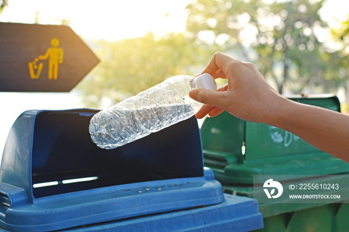 Close up hand holding empty bottle into the trash