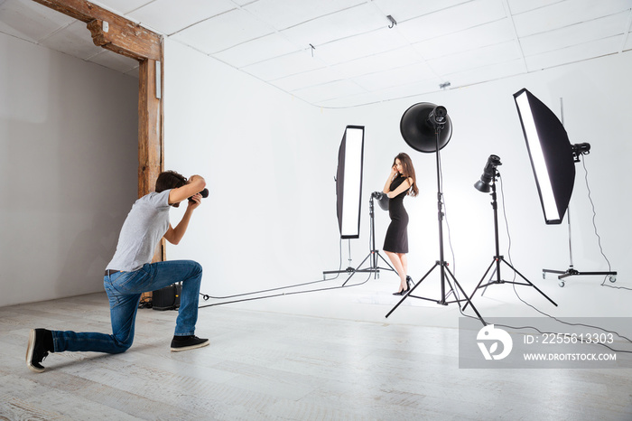 Photographer working with model in studio