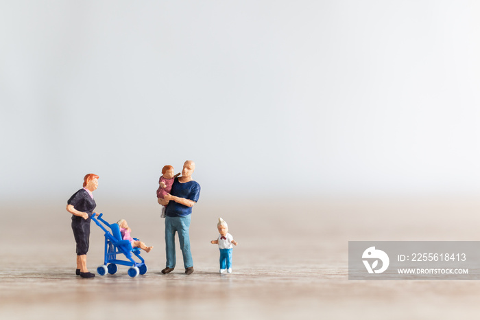 Miniature people : Parents with children walking outdoor , Happy family concept