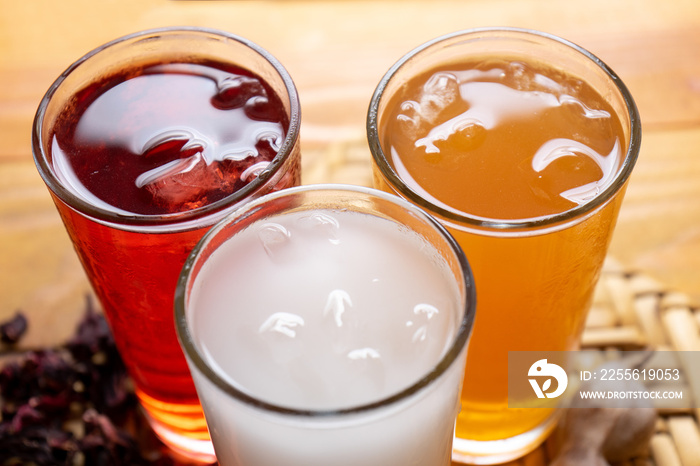 Set of mexican fresh water also called  aguas frescas . Hibiscus, tamarind and horchata on wooden ba