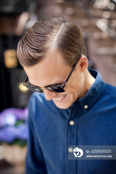 Happy man in sunglasses smiling outdoors