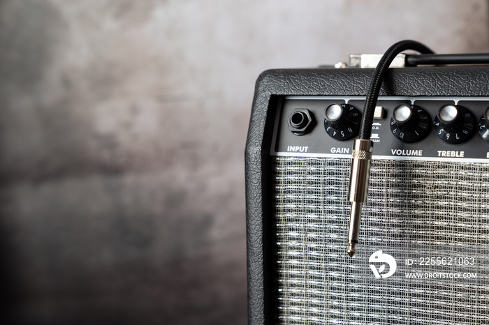 Close up of electric guitar amplifier with a audio cable. Shallow depth of field