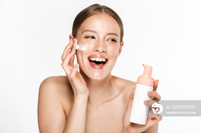 Image of beautiful half-naked woman rejoicing while washing her face with foaming facial cleanser