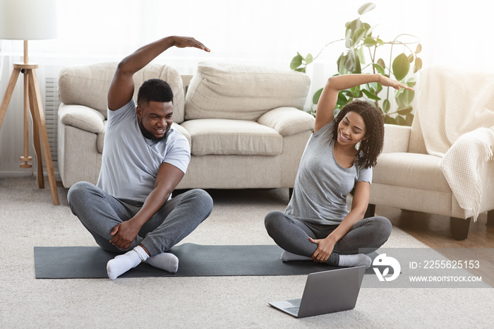 Young Happy African American Couple Training Together In Front Of Laptop