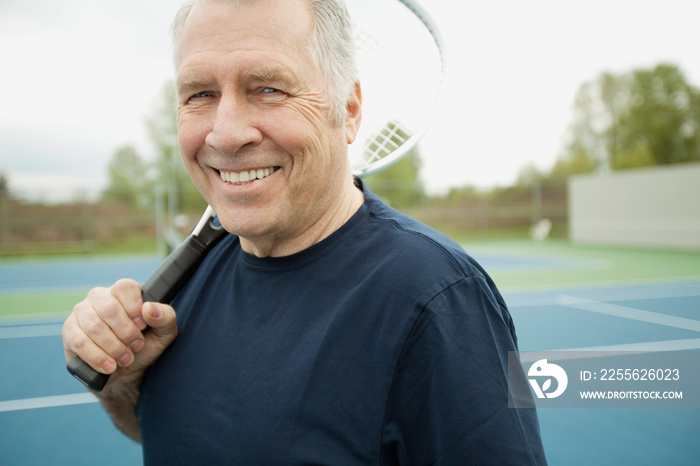 senior man with tennis racquet