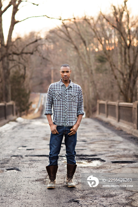 Portrait of man standing on bridge