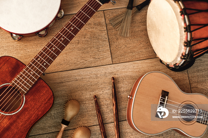 Ethnic musical instruments set: tambourine, wooden drum, brushes, wooden sticks, maracas and guitars