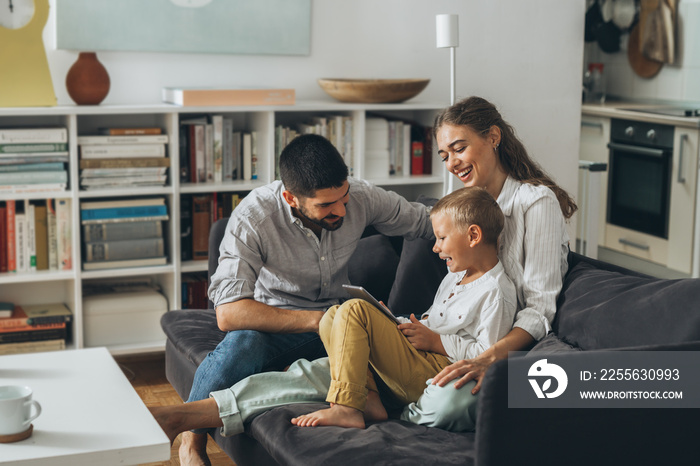 cute young family using tablet together at home