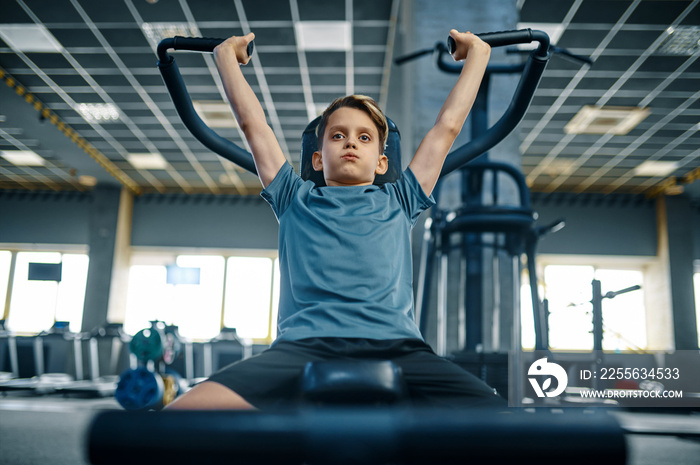 Boy on exercise machine, front view