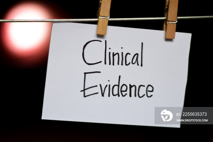 Clinical Evidence handwriting on paper. Hanged with a clothes clips, medical and education concept. 
