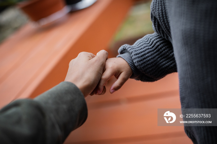 Close up of Black mother holding childs hand