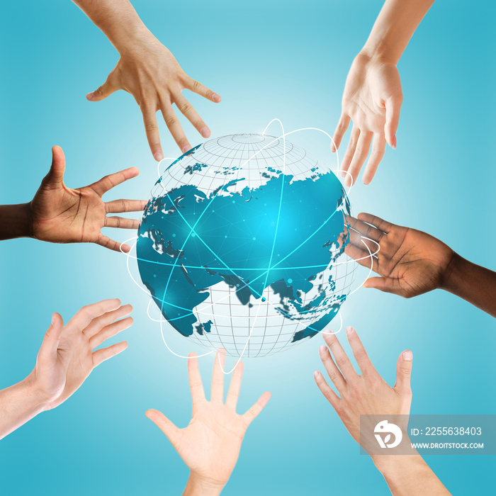 Hands surrounding globe on blue background. Concept of worldwide unity and environment protection