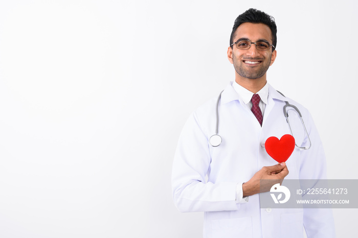 Young handsome Indian man doctor against white background