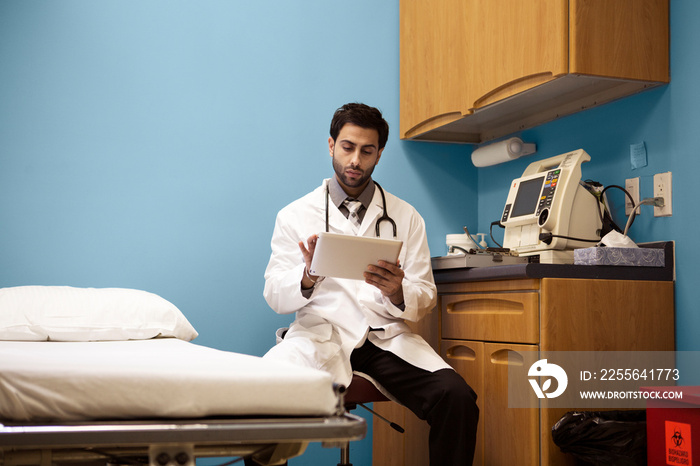 Doctor reading medical documents in hospital room