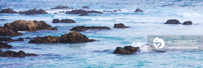 banner of blue sea with rocks