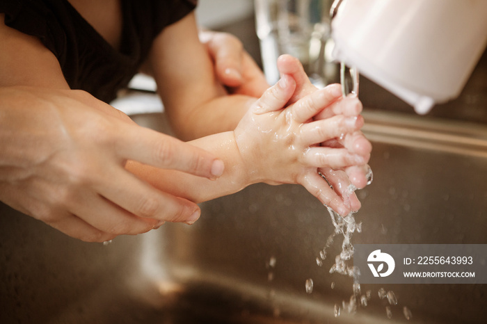 View of girl (2-3) washing hand