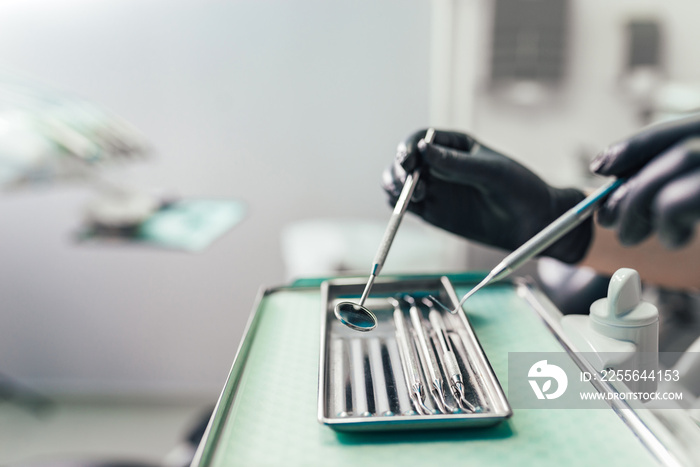 Close-up of dentist working with different tools for dental care.