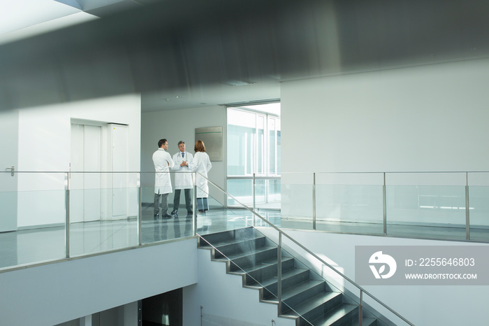 Doctors consulting in hospital corridor