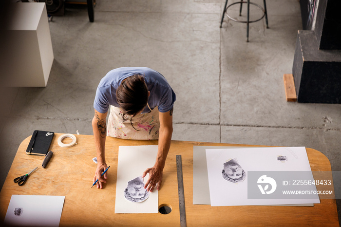 High angle view of artist sketching in studio