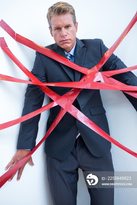 Businessman trapped by red tape